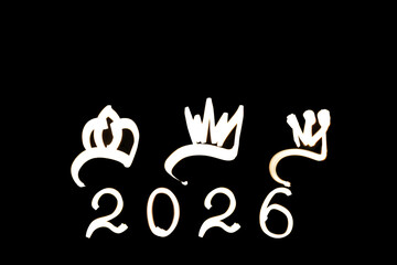 Obraz premium Light painting for 2026 Epiphany Day or Dia de Reyes Magos concept. Gold crowns, Star on black background