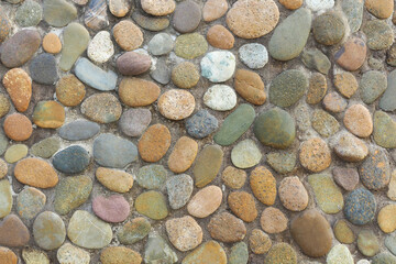 Colorful river pebble mosaic (or stone wall) texture background