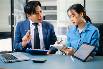 Business people meeting at office writing notes about sticky notes Laptop,tablet Planning and Brainstorming Strategies of Colleagues in office.