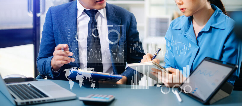 Team colleagues wear formal attire to work together to optimize business processes by using new technologies. high tech hologram in office background