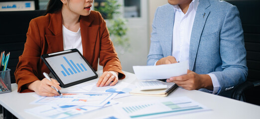 Business people meeting at office writing notes about sticky notes Laptop,tablet Planning and Brainstorming Strategies of Colleagues