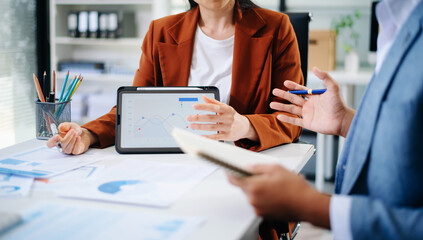 Business people meeting at office writing notes about sticky notes Laptop,tablet Planning and Brainstorming Strategies of Colleagues