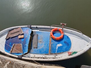 Ostia, Rome, Italy - September 5, 2025, a fisherman's boat docked along the Fishermen's Canal.