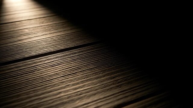 Close-up of textured wooden surface with light and shadow play, angled composition
