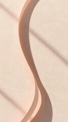 Minimal ribbon shadow on warm beige background, copy space.