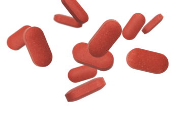 A large pile of red pills cascading, creating a striking visual representation of health essentials