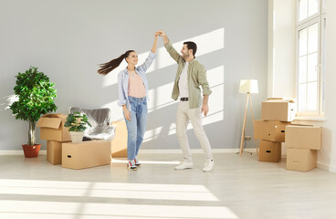 Happy overjoyed loving couple moving new flat, family relocation to modern apartment, husband, wife...