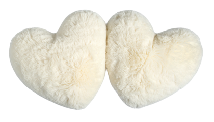 Two fluffy cream heart-shaped pillows nestled closely together