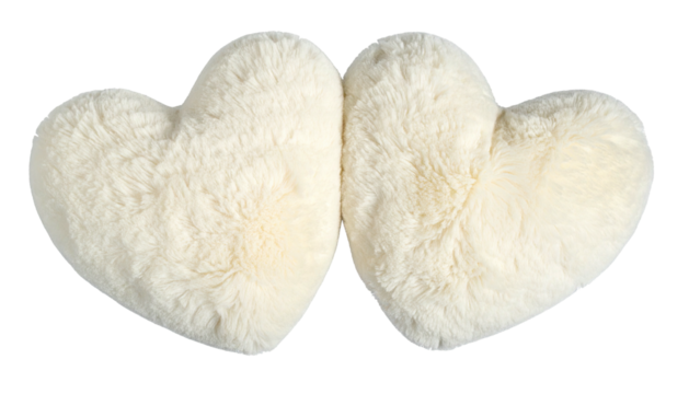 Two fluffy cream heart-shaped pillows nestled closely together