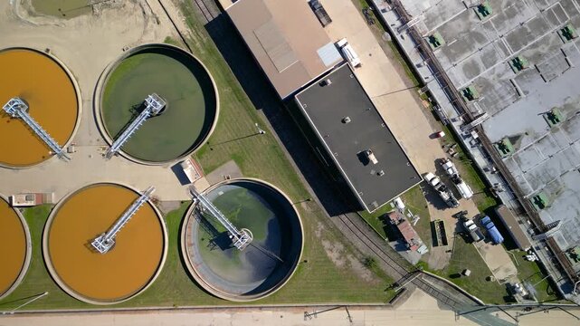 Top down view of waste water treatment plant processing colorful water.