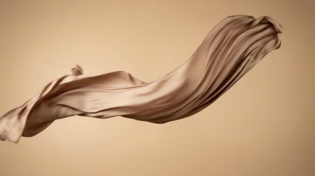Flowing silk fabric on a matching beige backdrop with soft, diffuse light
