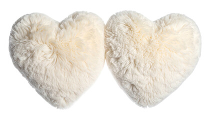 Two fluffy, ivory-colored heart-shaped cushions side by side