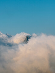 Mountain Peak Emerging from Clouds