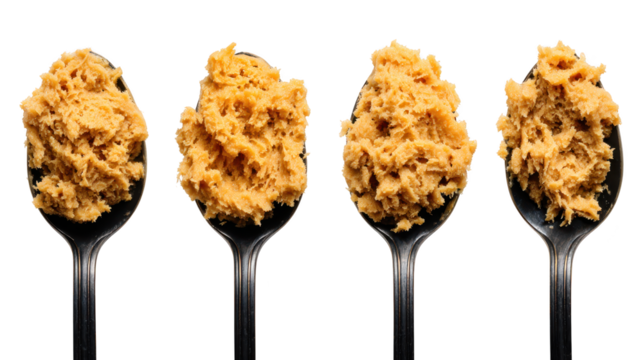 Spoon brimming with abundant soft substance utensil showcases generous helping of prepared sustenance