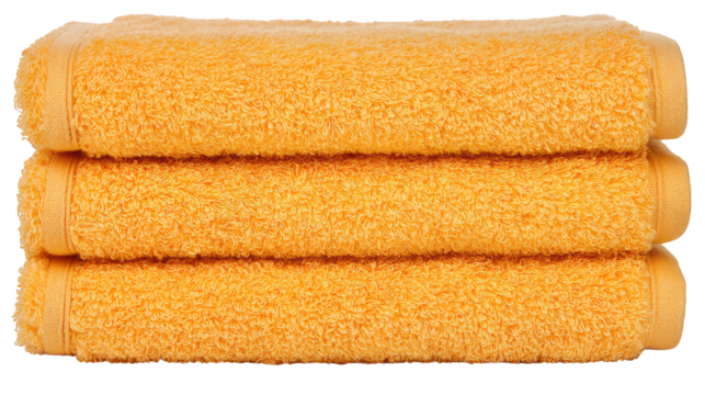 Yellow towels presented neatly on surface soft fabric towels brightly colored suitable for bath