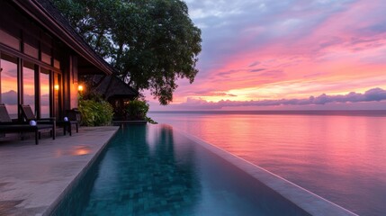 Fototapeta premium A serene tropical sunset by an infinity pool, reflecting vibrant colors over the calm ocean, perfect for travel articles, vacation rentals, or wellness retreats,