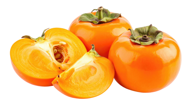 Orange-hued persimmons, one sliced, with green sepals and dark seeds