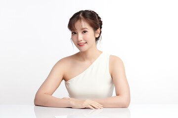 A beautiful young Asian woman with clean, fresh skin against a white background. Skincare, facial treatment, cosmetology, beauty, and spa. An elegant portrait of an Asian woman.