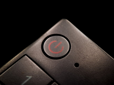 Textured surface shows an power symbol button, hinting at control and technological operation.