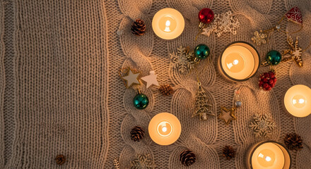 Warm Candlelit Holiday Scene with Knit Texture and Ornaments

