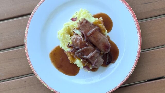 Rotating Plate of Bangers and Mash ( British Sausages and Mashed Potatoes with onion Gravy)