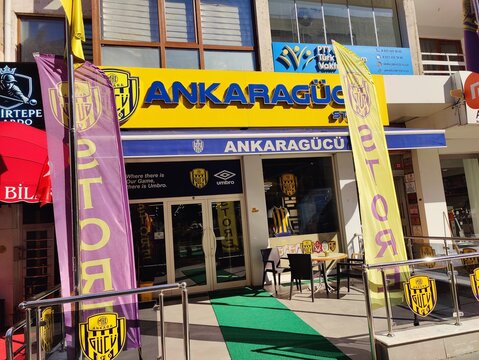 Ankara, Turkey, October 31, 2025Exterior of the MKE Ankarag&uuml;c&uuml; Football Club Official Store, Featuring Bright Yellow and Blue Signage, Club Flags, and Merchandise Displays in a Busy Urban Shopping.