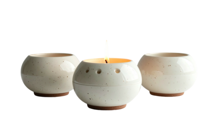 Lit candle surrounded by two similar, unlit candleholders