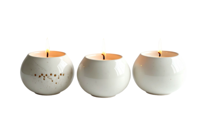 Three lit round candles arranged in a row against black