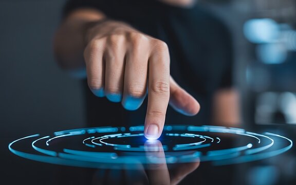 Hand activating a virtual futuristic interface with a glowing blue digital button