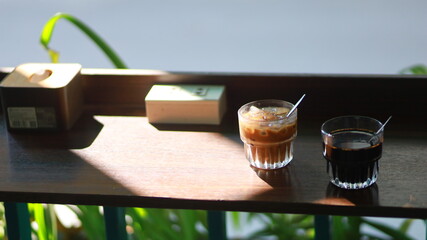 two cups of coffee on a corner table in a cafe