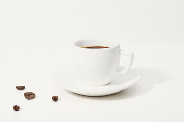 A cup of coffee and coffee beans on the table.  Copy space of your text.