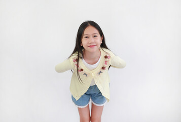 Sweet young Asian girl in yellow embroidered cardigan smiles and leans forward slightly, looking up...