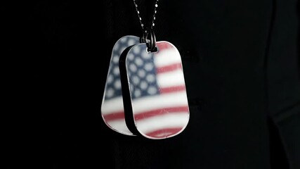 Symbolic American Flag Dog Tags Hanging Against a Dark Background, Representing Patriotism and Military Service