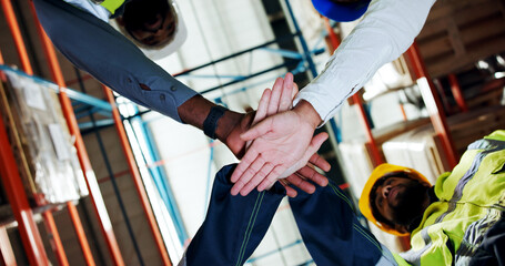 Hands together, team and low angle at warehouse for logistics, motivation or connection for career at plant. People, group and stack for supply chain, celebration or inventory management for shipping © peopleimages.com