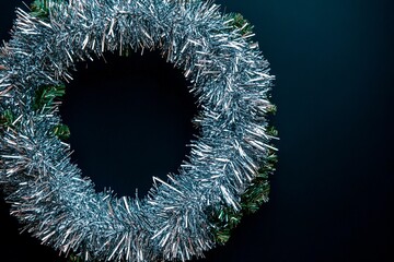 Creative wreath of interwoven rains with a blank square note nearby under soft lighting