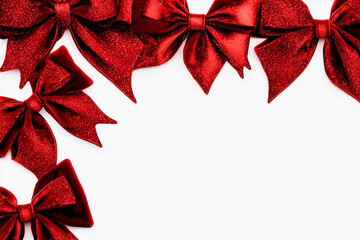 Festive arrangement with glittering red bows and velvet ribbons perfect for holiday greetings or celebration decorations