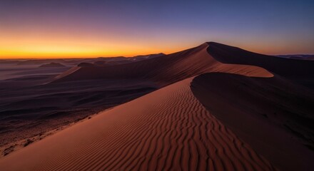 Majestic desert dunes are bathed in vibrant, warm light at sunset or sunrise