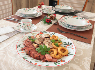 Table setting with bright tableware, berries, and twigs. Aesthetics and lifestyle. Interior design. Meat platter, appetizer. 