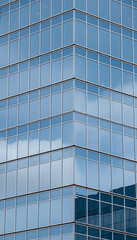 Obraz premium Tall Glass Skyscraper Against Blue Sky