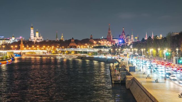 The Kremlin Embankment and the Moskva River, with fast-moving clouds in the night sky