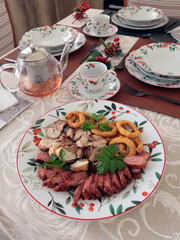 Table setting with bright tableware, berries, and twigs. Aesthetics and lifestyle. Interior design. Meat platter, appetizer. 