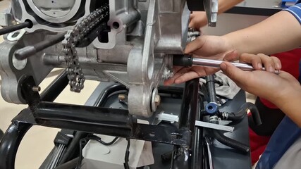 Automotive Mechanic Repairing Engine and Cutaway Model for Technical Training