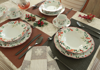 Table setting with bright tableware, berries, and twigs. Italian ceramic tableware. Aesthetics and lifestyle. Interior design. 