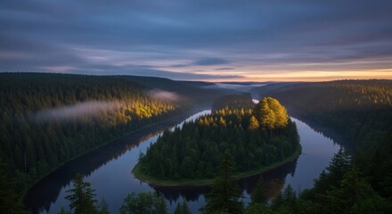 Aerial view of a winding river surrounded by lush green forests at dusk with soft light