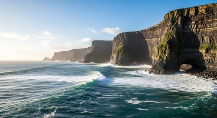 Scenic vista of jagged cliffs meeting the ocean under a clear sky