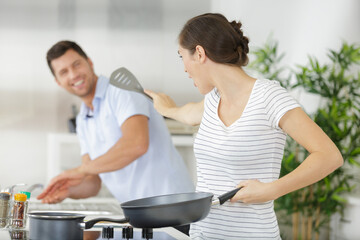 romantic couple is cooking on kitchen