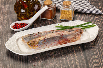 Salted marinated herring fillet with spices