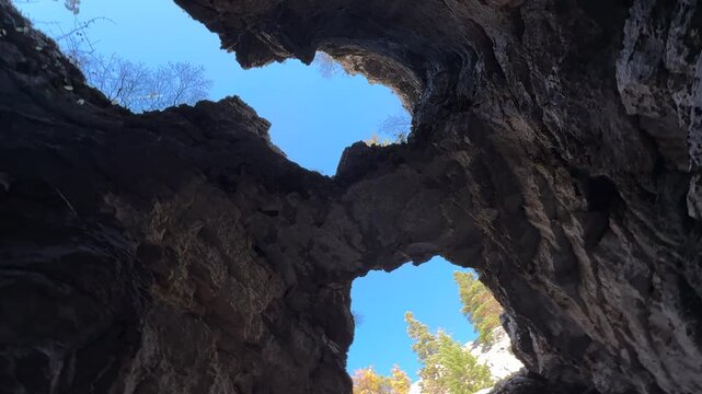 The huge holes and views that open up to the sky from the caves located in the wild geography