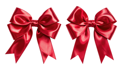 Two vibrant, shiny, tied red satin bows, isolated