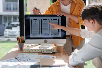 Designers collaborating on mobile app user interface development